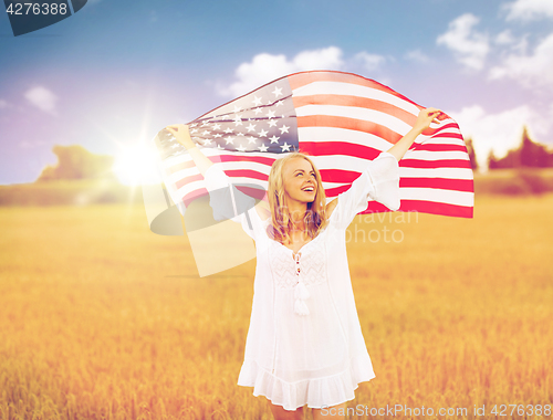 Image of happy woman with american flag on cereal field