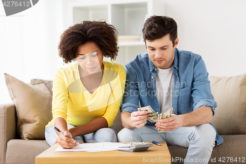 Image of couple with papers and calculator at home