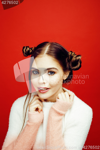 Image of young pretty emitonal posing teenage girl on bright red background, happy smiling lifestyle people concept closeup