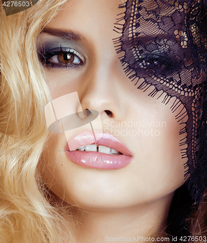 Image of portrait of beauty young woman through lace close up mistery makeup sexy, fashion people concept