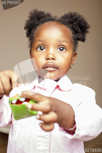 Image of little cute african american girl playing with animal toys at home, pretty adorable princess in interior happy smiling, lifestyle people concept