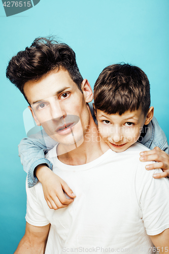 Image of young pretty man model with little cute son playing together, lifestyle modern people concept, family male
