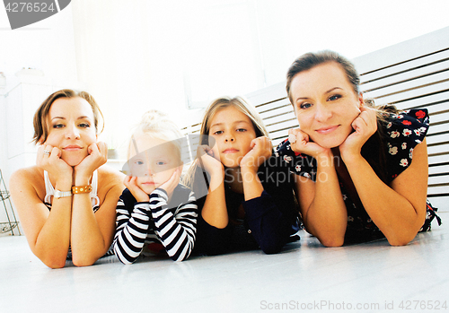 Image of Mature sisters twins at home with little daughter, happy family 