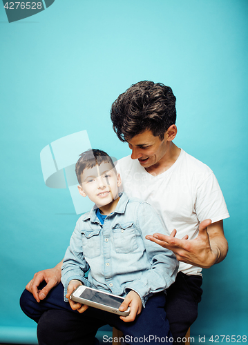 Image of young pretty man model with little cute son playing together, lifestyle modern people concept, family male