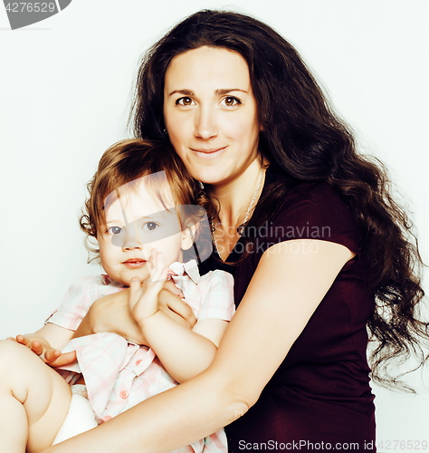 Image of young mother with little cute daughter on white, happy smiling family inside isolated adorable, lifestyle modern people concept