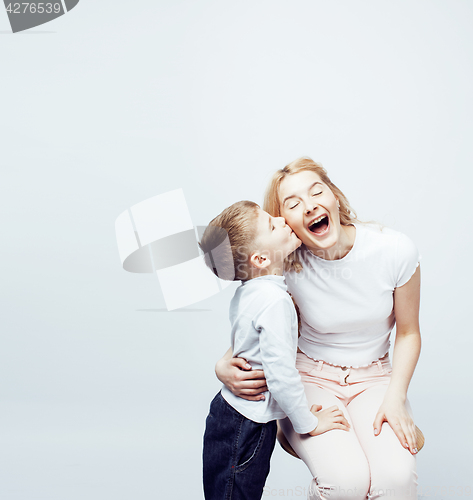 Image of young modern blond curly mother with cute son together happy smiling family posing cheerful on white background, lifestyle people concept, sister and brother friends 