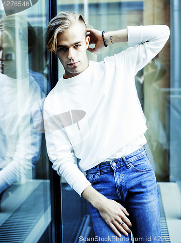 Image of young modern hipster guy at new building university blond fashion hairstyle having fun, lifestyle people concept 