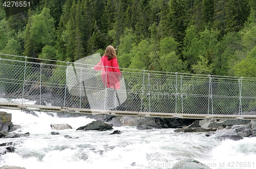 Image of Woman on suspension bridge