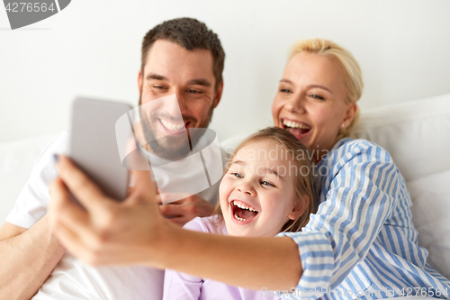 Image of happy family taking selfie by smartphone at home