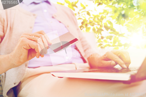 Image of senior woman with laptop and credit card