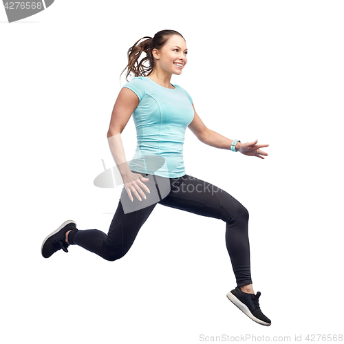Image of happy smiling sporty young woman jumping in air