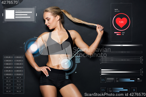 Image of young woman in black sportswear posing 