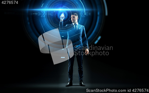 Image of businessman in suit touching virtual projection