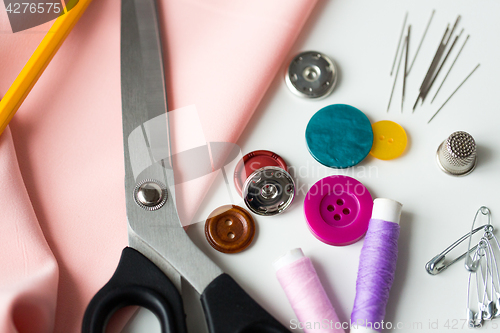 Image of scissors, sewing tools and cloth