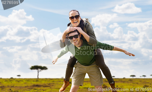 Image of smiling couple with backpacks traveling in africa