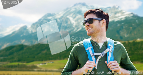 Image of happy man with backpack traveling in highlands