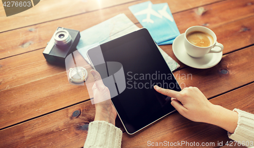 Image of close up of traveler hands with tablet pc and map