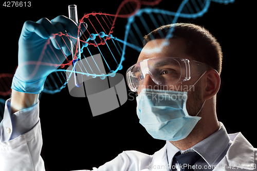 Image of scientist with test tube and dna molecule