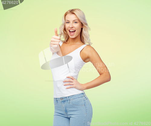 Image of happy young woman showing thumbs up