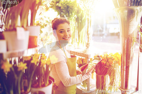 Image of woman with tablet pc computer at flower shop