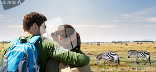 Image of happy couple with backpacks traveling