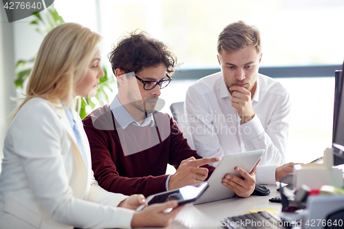 Image of business team with tablet pc at office