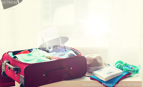 Image of close up of travel bag with clothes and stuff