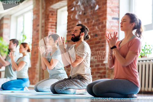 Image of group of people meditating at yoga studio