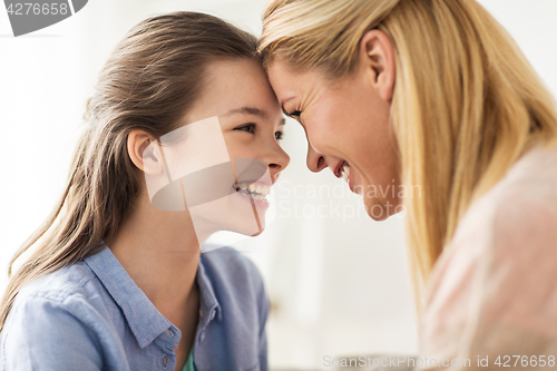 Image of happy smiling family of girl and mother at home