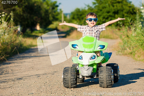 Image of Happy little boy playing on road at the day time.