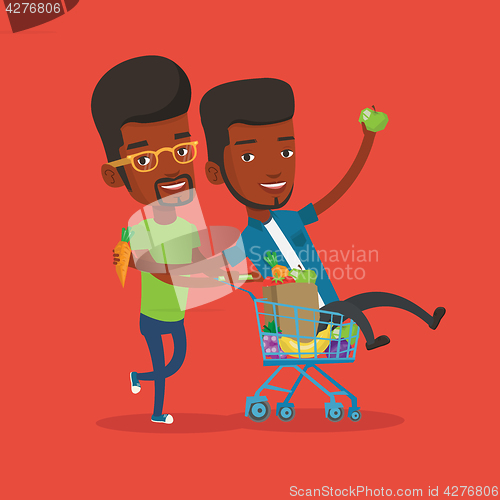 Image of Two young friends riding by shopping trolley.
