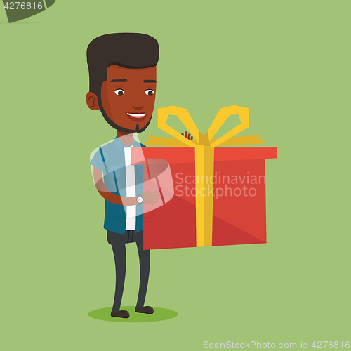 Image of Joyful african-american man holding box with gift.