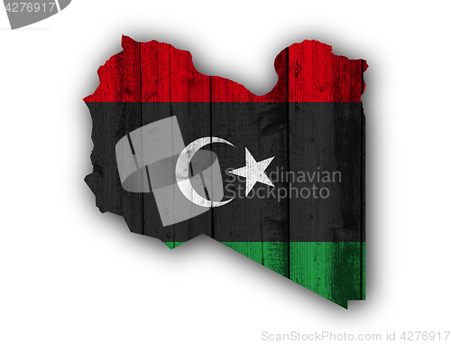 Image of Map and flag of Libya on weathered wood