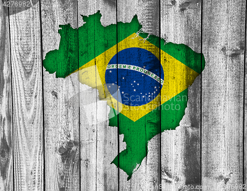 Image of Map and flag of Brazil on weathered wood