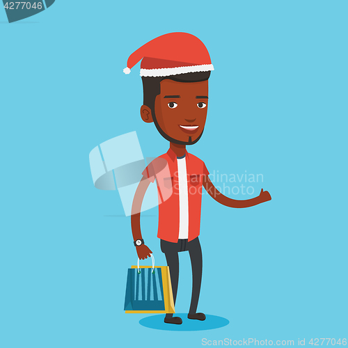 Image of Man in santa hat shopping for christmas gifts.