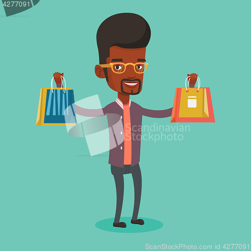 Image of Happy man holding shopping bags.