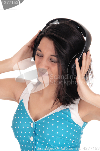 Image of Woman listening to music with headphones.