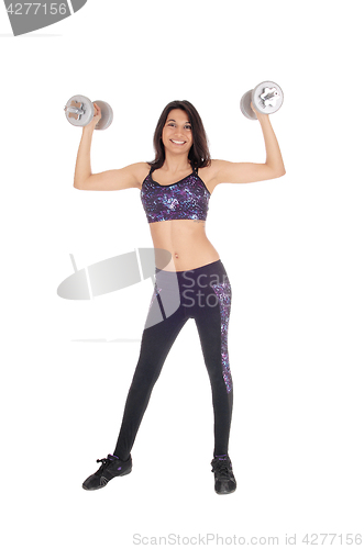 Image of Beautiful woman lifting dumbbells.