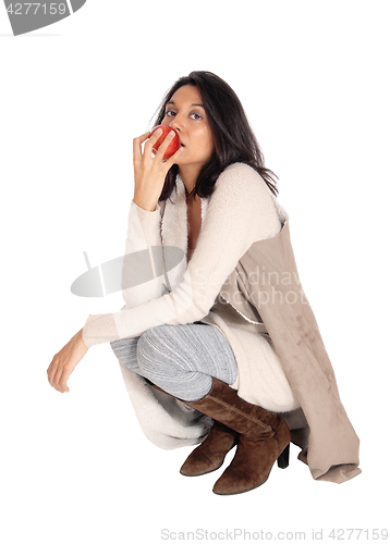 Image of Woman eating red apple.