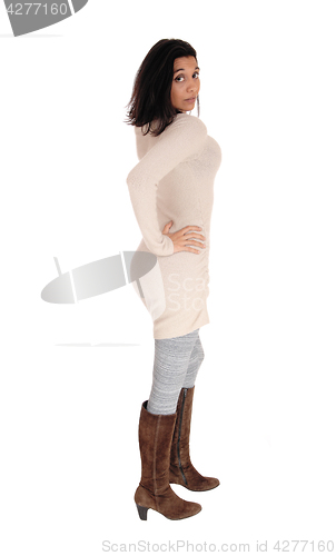 Image of Woman standing in a knitted dress.