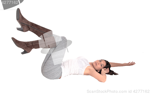 Image of Young woman lying on floor.