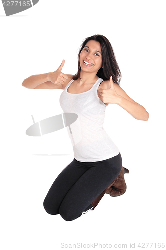 Image of Woman kneeling with thumps up.