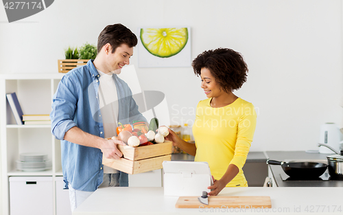 Image of happy couple with healthy food at home kitchen