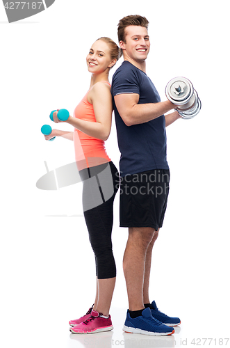 Image of sportive man and woman with dumbbells
