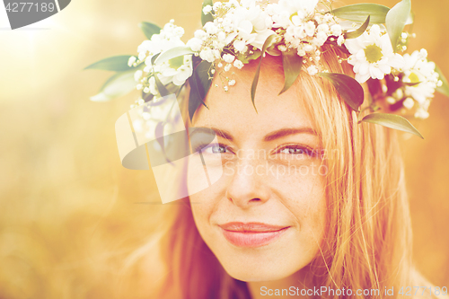 Image of happy woman in wreath of flowers