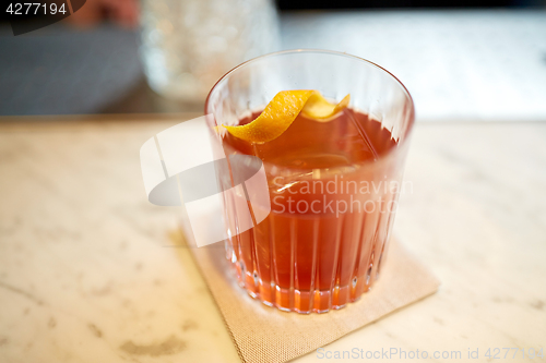 Image of glass of alcohol cocktail on bar counter