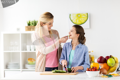 Image of happy family cooking dinner at home kitchen