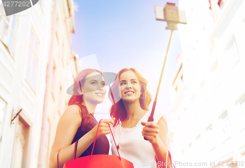 Image of women shopping and taking selfie by smartphone