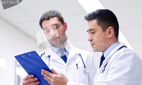 Image of two doctors at hospital with clipboard