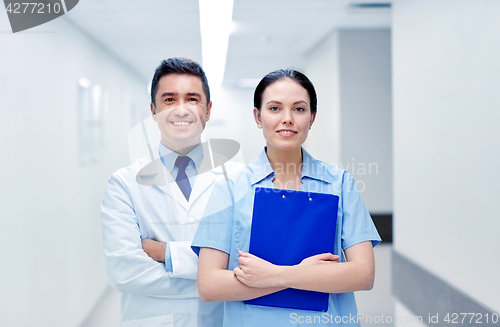 Image of smiling medics at hospital with clipboard